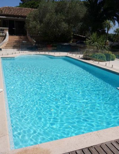 Glass safety barrier around swimming pool