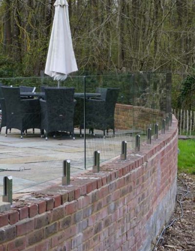Glass wind-break mounted on wall