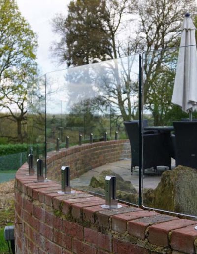 Wind protection glass fence installation on wall