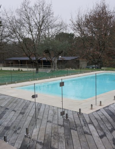 Frameless glass pool fence in terrace and decking